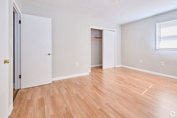 an empty living room with wood flooring and a closet at Fay Street Apartments, Winchester, 22601